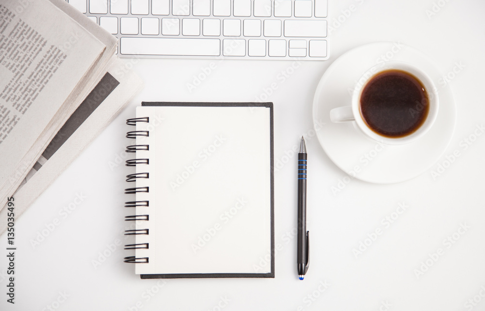 A dairy, a keyboard, a pen and a newspaper A dairy, a keyboard, a pen and a newspaper