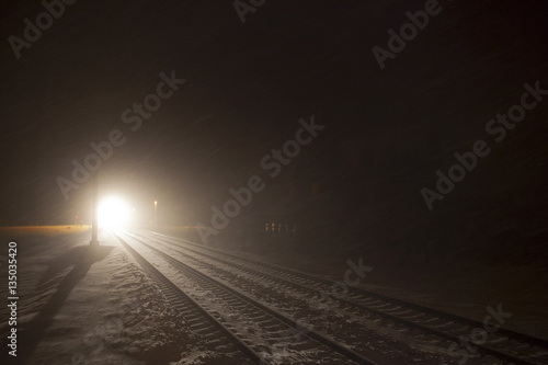 headlights of train in winter night