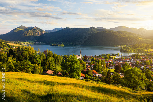 View of mountains and mountain lake during sunset in summer. Beautiful town of Schliersee in Bavaria, Germany, Europe.