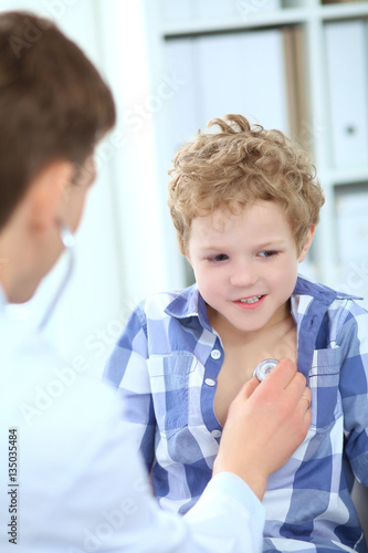 Doctor examining a child patient chest by stethoscope.