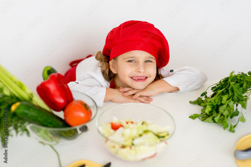 little girl chef is going to prepare a salad isolated little girl chef is going to prepare a salad isolated