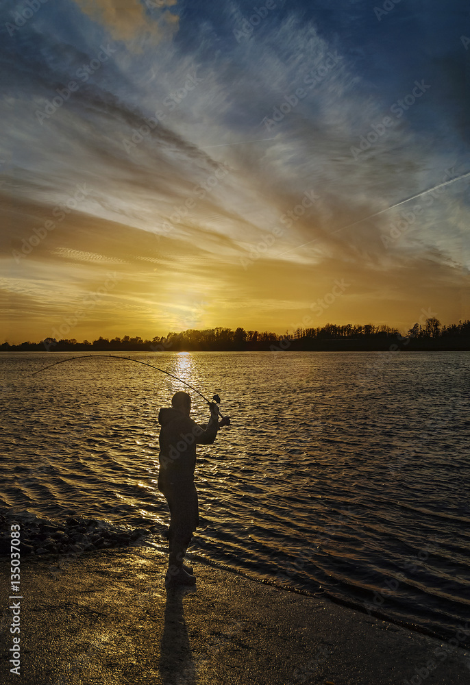 Fototapeta premium Wintertime with angler