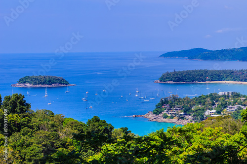 Beautiful landscape of turquoise ocean waves with boats, coastli photo