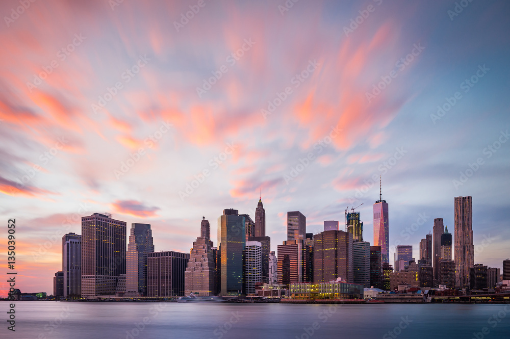 View of the New York Lower Manhattan buildings with colorful clouds above