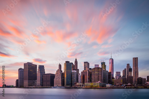 View of the New York Lower Manhattan buildings with colorful clouds above © VOJTa Herout