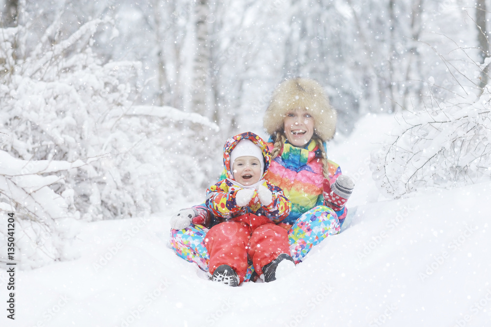 mom and little daughter on a winter walk in the park white mom and little daughter on a winter walk in the park white