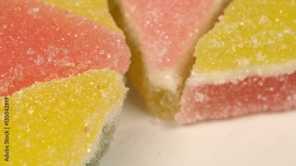 Multicolored marmalade on a triangular rotating turntable 4K Multicolored marmalade on a triangular rotating turntable 4K