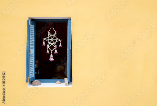 Wood thai tradition window on yellow wall background with copy space