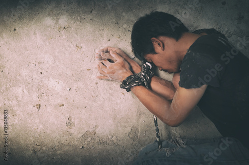 hopeless man hands tied together with rope photo