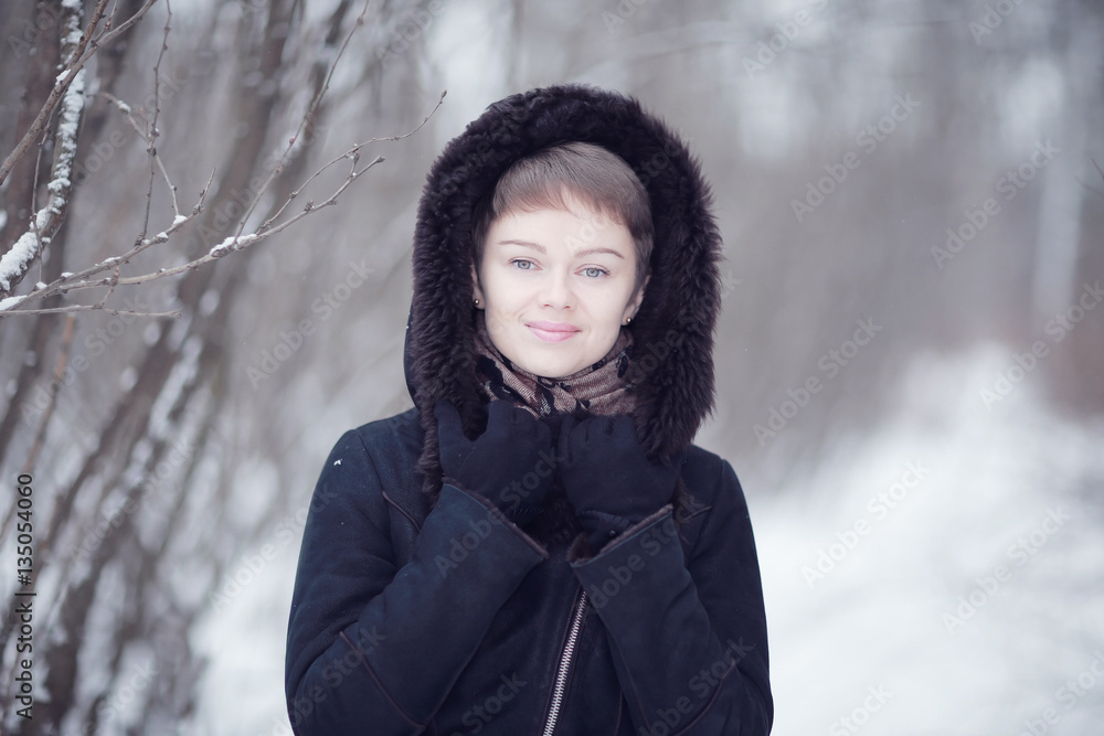 Winter woman in a fur coat on the snow outside Winter woman in a fur coat on the snow outside