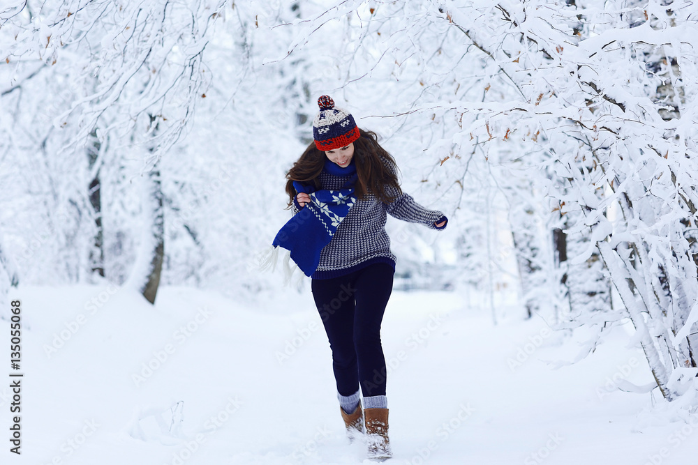 Girl running in winter park snow vacation