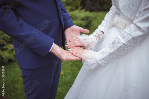 bride and groom holding hands. © toomler