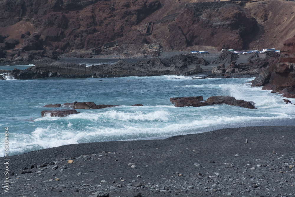 Obraz premium Wild sea and volcanic lava rocks west coast of Lanzarote island,