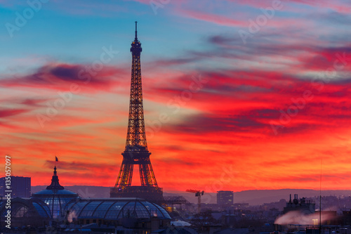 Aerial view of Eiffel tower and the rooftops of Paris during a gorgeous sunset, France © Kavalenkava