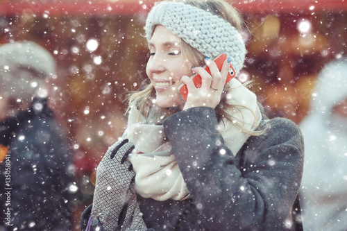 happy girl talking on the phone city snow winter christmas