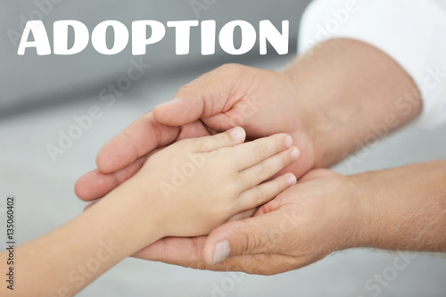 Adoption concept. Grandfather holding hand of grandchild