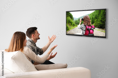 Family watching television ...