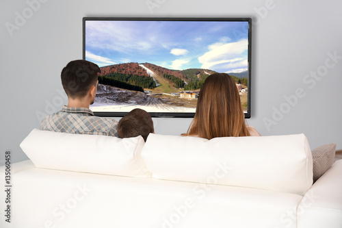 Family watching television ...