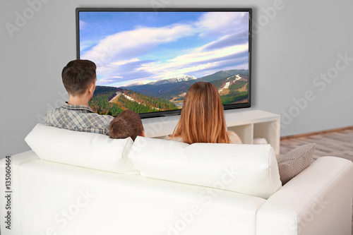 Family watching television ...