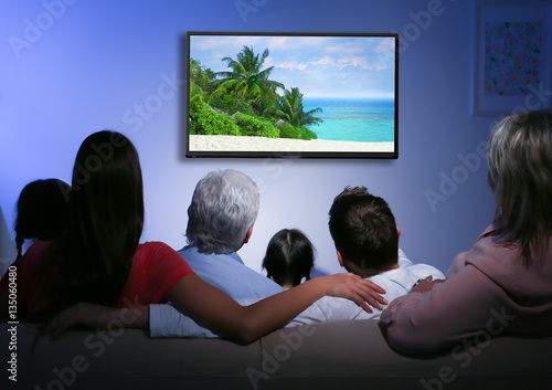 Family watching television ...