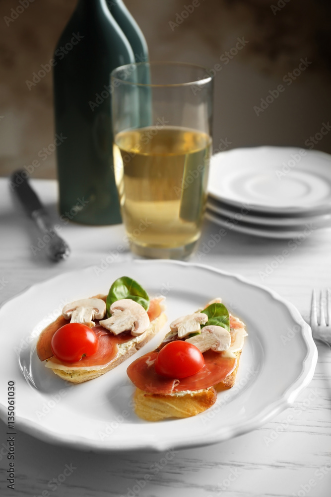 Plate with delicious bruschetta on table