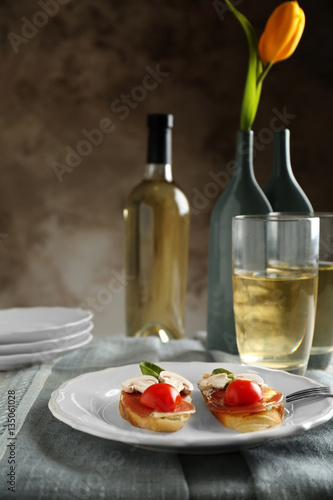 Plate with delicious bruschetta on table