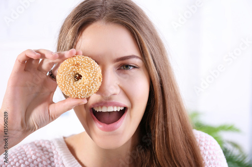 Young woman with cookie at ...