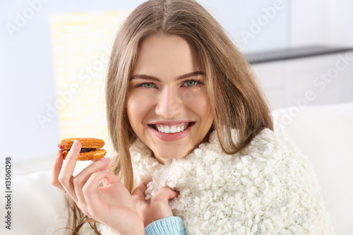 Young woman eating cookie, ...
