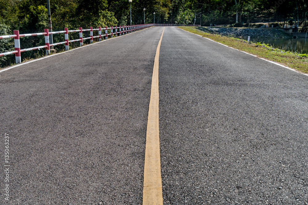 Asphalt road with yellow line Asphalt road with yellow line