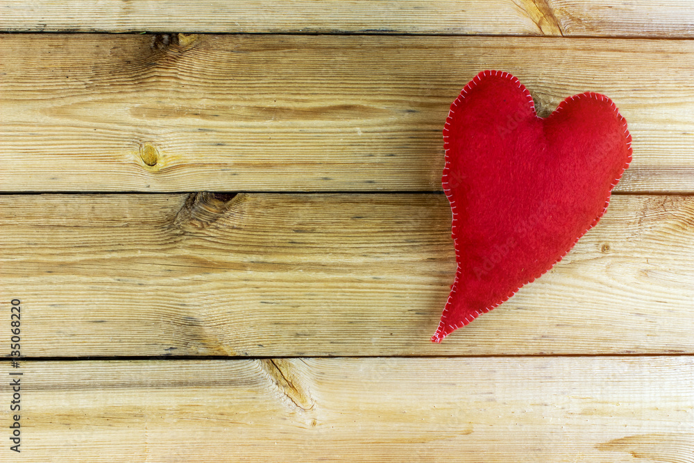 Fluffy elongated red heart, hand made on the old wooden table Fluffy elongated red heart, hand made on the old wooden table