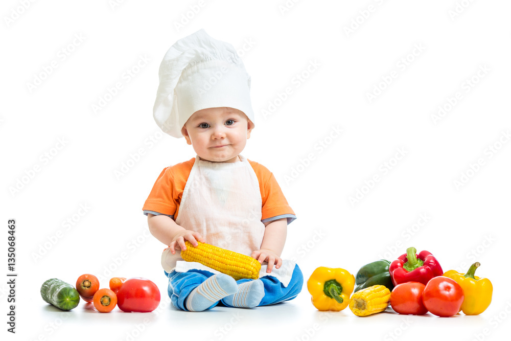 Smiling chef kid boy with vegetables isolated on white background Smiling chef kid boy with vegetables isolated on white background