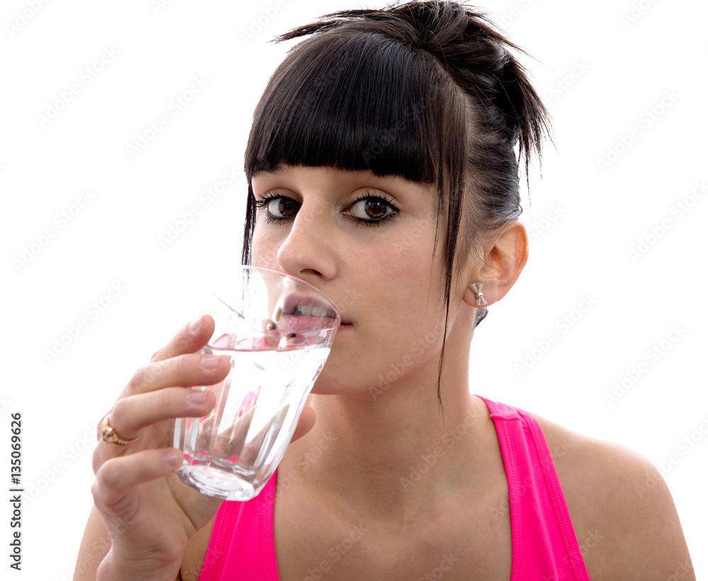 young girl drinks a glass of water, on white young girl drinks a glass of water, on white
