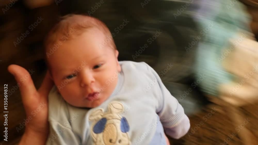 world spinning around newborn baby - on father's hands world spinning around newborn baby - on father's hands