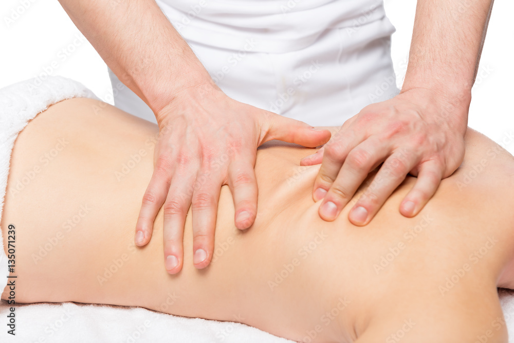 male masseur does back massage on a massage table male masseur does back massage on a massage table