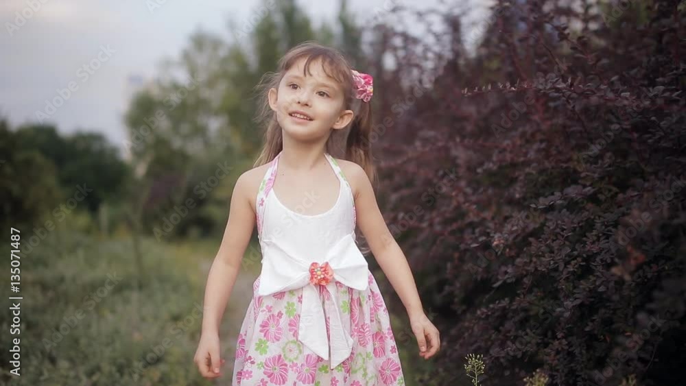 Girl spinning in park and smiling Girl spinning in park and smiling