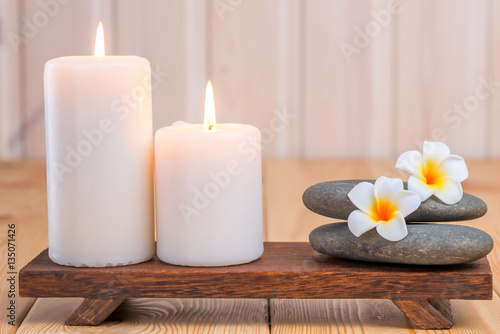 stones for massage and frangipani flowers in composition with ca