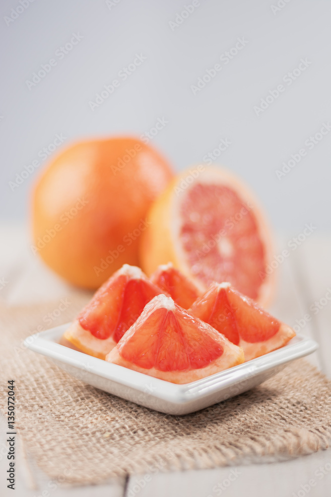 Slices of grapefruit on a wooden table. Slices of grapefruit on a wooden table.