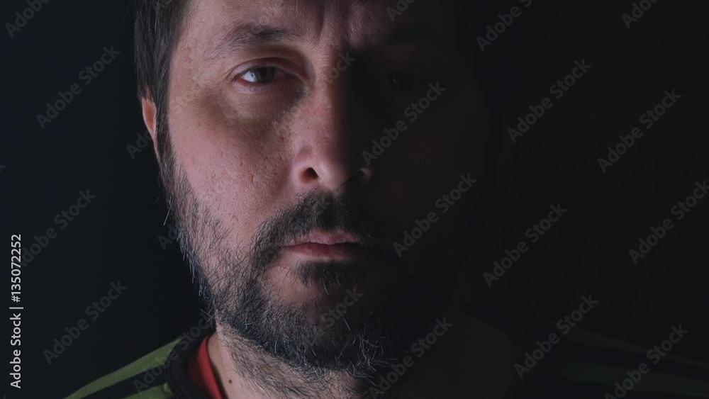 Portrait of adult thoughtful pensive man with beard standing by the window and thinking Portrait of adult thoughtful pensive man with beard standing by the window and thinking