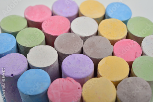 Macro picture of chalks in a variety of colors on a white backgr