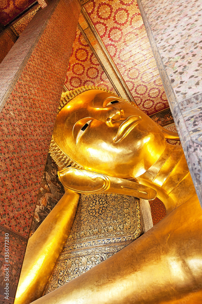 Reclining Gold Buddha statue at the Wat Pho In Bangkok Thailand 