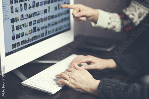 Homecarer with elderly woman using laptop computer photo