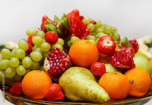 full glass vase of ripe tasty fruit
