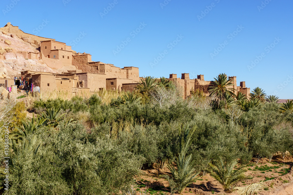 Aït Benhaddou is an ighrem (fortified village in English) (ksar in Arabic), along the former caravan route between the Sahara and Marrakech in Morocco