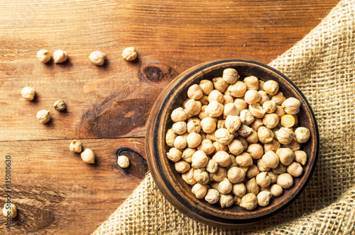 Portion of Chick Peas in wooden bowl photo