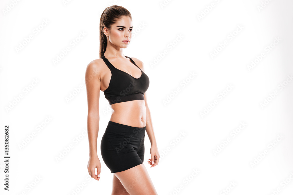 Side view of a young sexy fitness woman in sportswear Side view of a young sexy fitness woman in sportswear