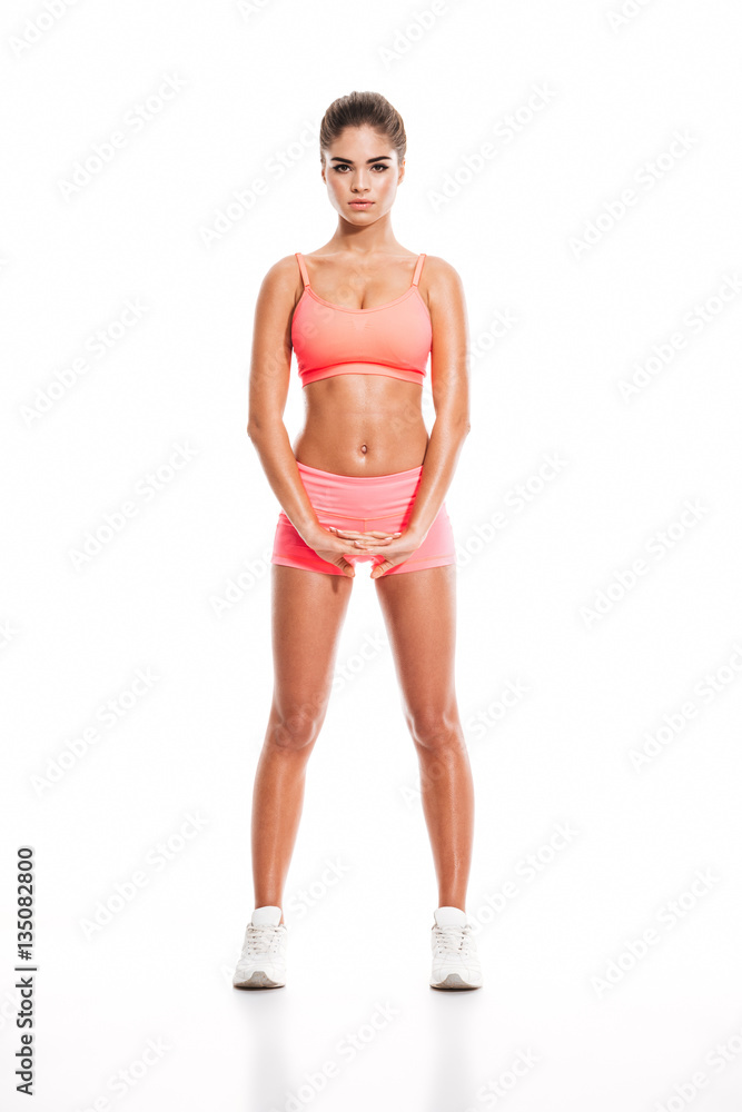 Portrait of a young sexy woman standing and stretching hands