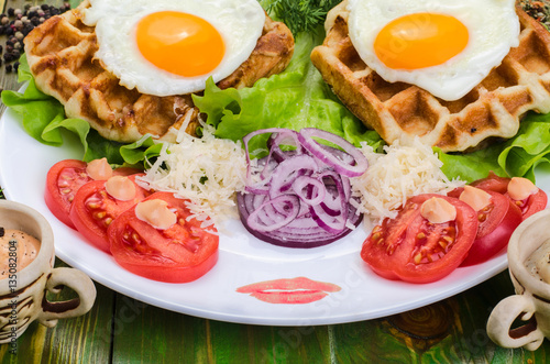 Fried eggs and tomatoes on a white plate.