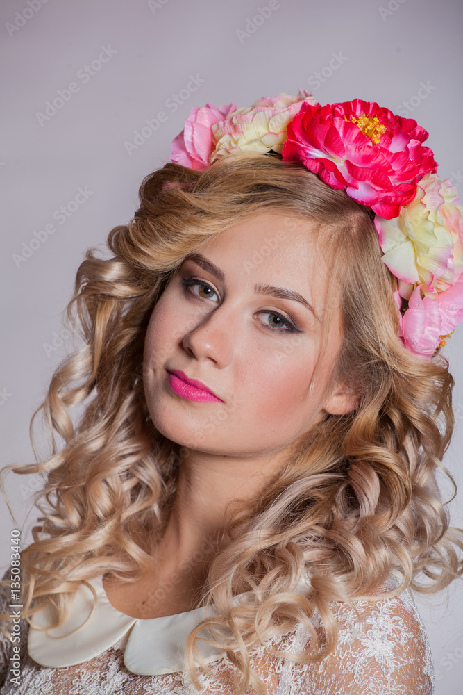 Fototapeta premium young and beautiful blonde with a wreath of flowers in her hair