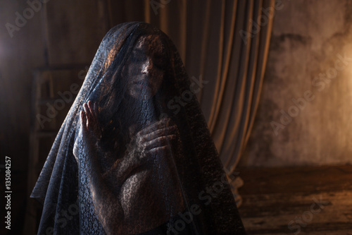 Fototapeta Mysterious portrait of beautiful woman in black lace veil