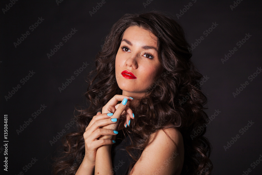 Obraz premium young and beautiful brunette on black fonev black dress